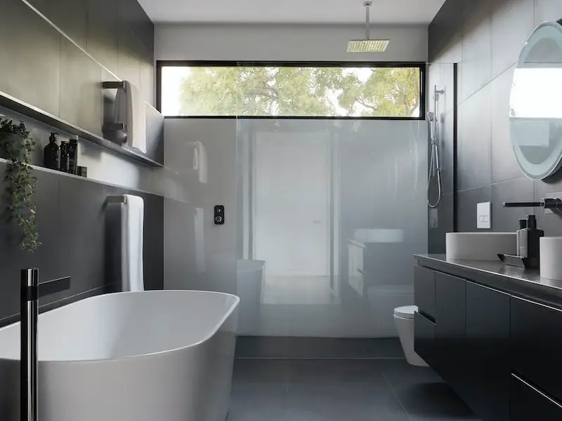 white ceramic bathtub near white bathtub