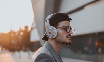 shallow focus photography of man wearing Beats wireless headphones