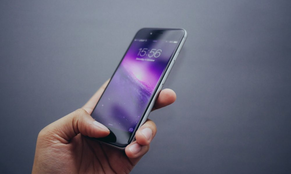 person holding space gray iPhone X