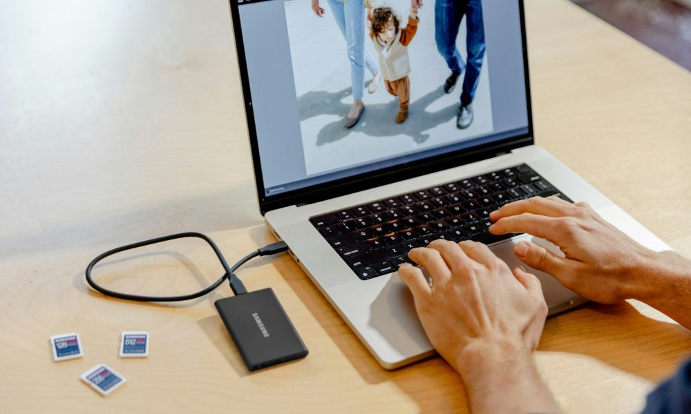 A person using a laptop computer on a table