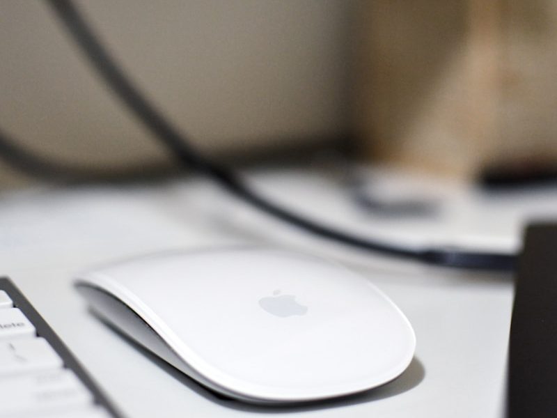 a computer mouse sitting on top of a white desk
