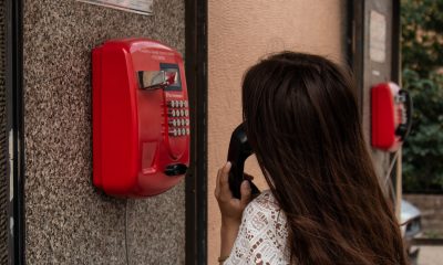 woman using payphone