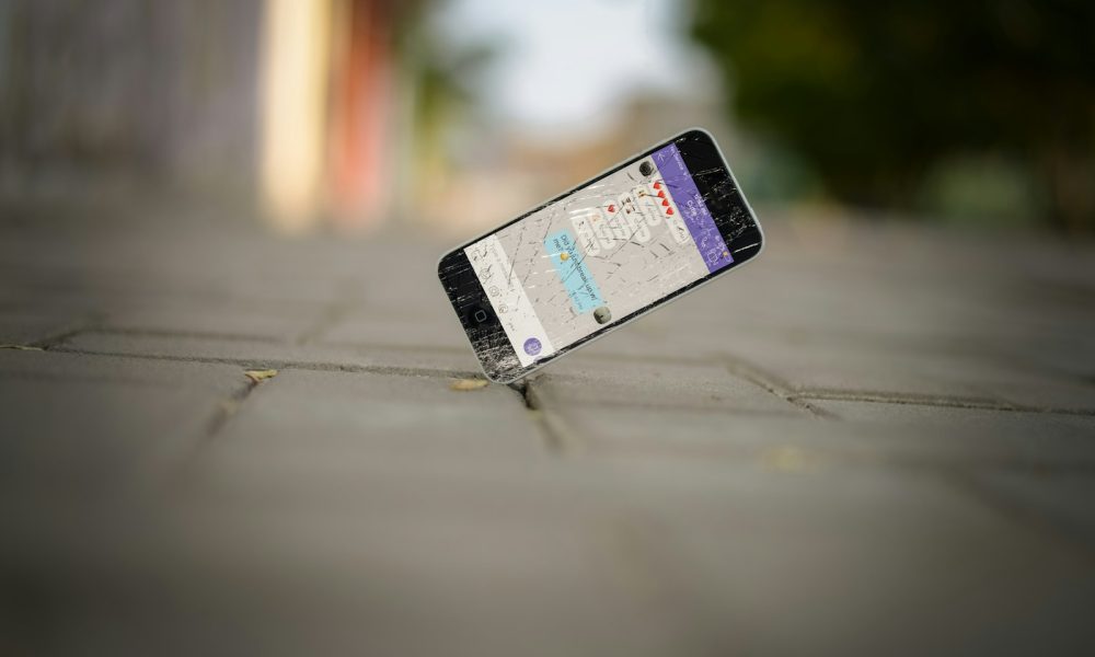 selective focus photo of iPhone balance on brick pavement