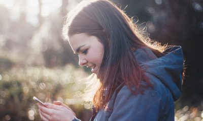 woman holding phone smiling