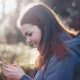 woman holding phone smiling