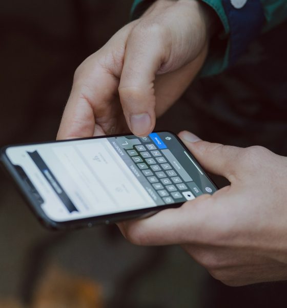 selective focus photography of person using smartphone