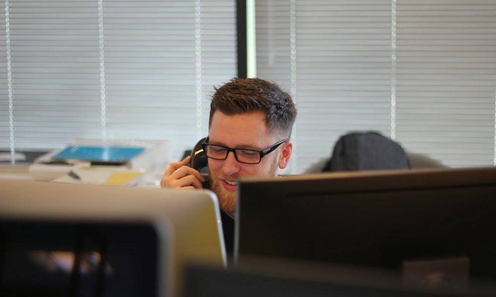 man using IP phone inside room