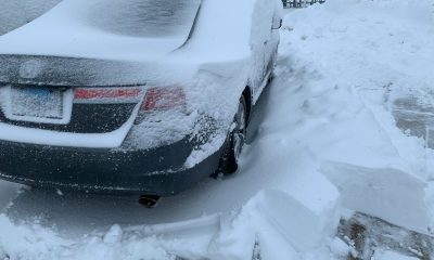 Car covered in deep snow after a blizzard.
