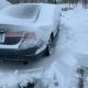 Car covered in deep snow after a blizzard.